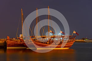 Traditional dhows mooring in Doha in Qatar during night