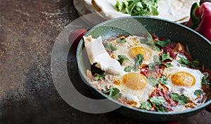 Traditional dish of israeli cuisine Shakshuka on dark background