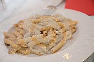 Traditional dish pasta with mushrooms and potatoes cream parmiggiano chhese on table in restaurant lunch food