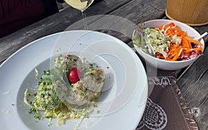 traditional dish of three different dumplings served with a salad photo
