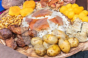 Traditional dishes of Ecuadorian highlands: mote, hornado, fritada, pig\'s skin, potatoes photo