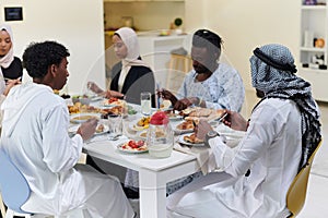 A traditional and diverse Muslim family comes together to share a delicious iftar meal during the sacred month of