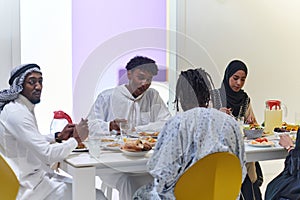 A traditional and diverse Muslim family comes together to share a delicious iftar meal during the sacred month of