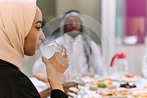 A traditional and diverse Muslim family comes together to share a delicious iftar meal during the sacred month of