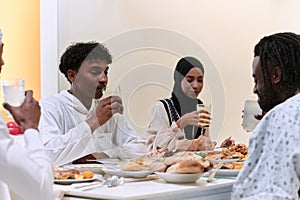 A traditional and diverse Muslim family comes together to share a delicious iftar meal during the sacred month of