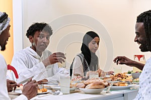 A traditional and diverse Muslim family comes together to share a delicious iftar meal during the sacred month of