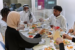 A traditional and diverse Muslim family comes together to share a delicious iftar meal during the sacred month of