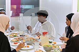 A traditional and diverse Muslim family comes together to share a delicious iftar meal during the sacred month of