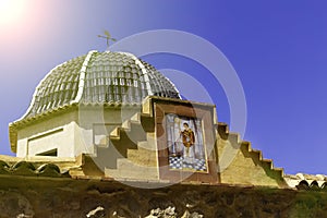 Traditional dome with blue ceramic tiles and the image of the saint in the church Relleu, Alicante province