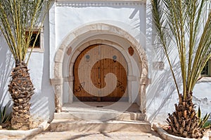 Traditional door with pattern and tiles, Hara Sghira Er Riadh - Djerbahood in Tunisia