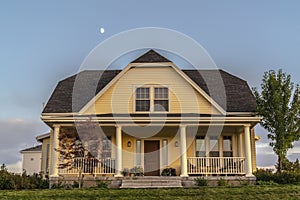 Traditional double storey timber clad yellow house