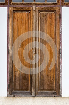 Traditional double wooden window vintage style on the old cement wall for background and texture of house and building