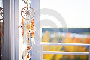 traditional dream catcher as wind chime hanging outside