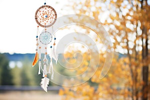 traditional dream catcher as wind chime hanging outside