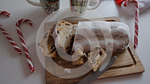 Traditional Dresdner German Christmas cake Stollen with Marzipan, Berries Nuts, Cinnamon, Raising on a rustic wooden