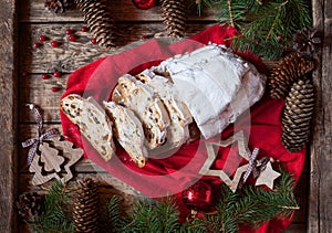 Traditional Dresdner German Christmas cake Stollen with raising, berries and nuts. Holiday xmas decorations. photo