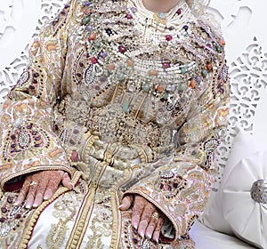 The traditional dress of the Moroccan bride. Beautiful bride wearing Moroccan caftan and precious jewelry