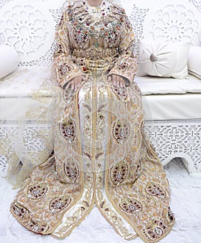 The traditional dress of the Moroccan bride. Beautiful bride wearing Moroccan caftan and precious jewelry