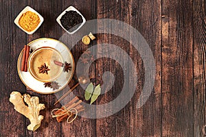 Traditional drink with spices,Indian masala chai tea with milk, ginger, anise and cinnamon on an old wooden table. cafe concept,