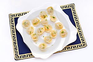Traditional dumplings with filling and greens