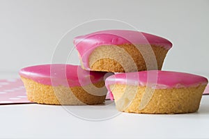 Traditional Dutch cake with pink frosting, called Roze Koek. .on white table photo