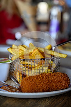 Traditional Dutch fast food snacks, fricandel and french fried potato chips