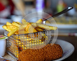 Traditional Dutch fast food snacks, fricandel and french fried potato chips