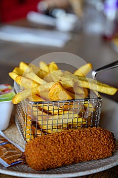 Traditional Dutch fast food snacks, fricandel and french fried potato chips