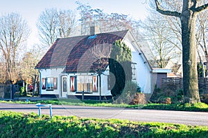 Traditional dutch house with beautiful red white blinds or shutters