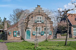 Traditional Dutch house with stepped gable and coloured shutters