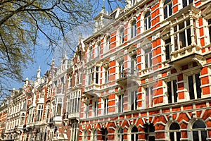 Traditional dutch old facades located on Weesperzijde Street along Amstel river, Amsterdam