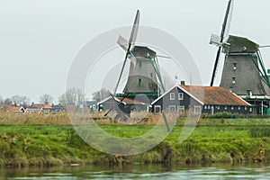Traditional Dutch village with old windmills and river landscape