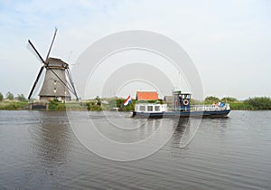 Traditional Dutch Windmill and Boat on the canal at Kinderdijk