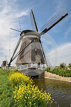 Traditional dutch windmill near a canal in the little town of Zevenhuizen, close to Rotterdam, Holland