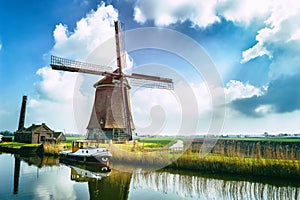 Traditional dutch windmill near the canal photo