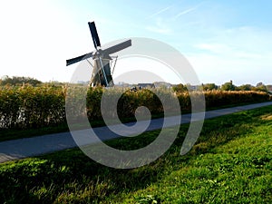 Traditional dutch windmill near the canal. Netherlands