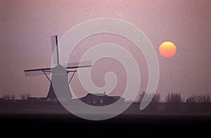 Traditional Dutch windmill at sunset in Holland