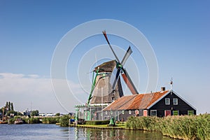 Traditional dutch windmill at the Zaan river photo