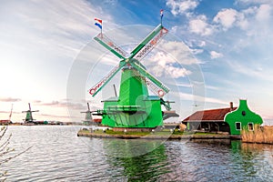 Traditional Dutch windmills against colorful sunset in Zaanse Schans, Amsterdam area, Holland