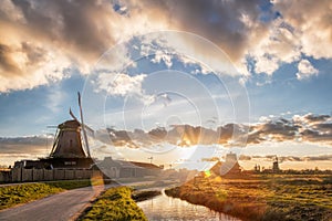 Traditional Dutch windmills against sunset in Zaanse Schans, Amsterdam area, Holland