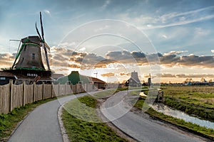 Traditional Dutch windmills against sunset in Zaanse Schans, Amsterdam area, Holland