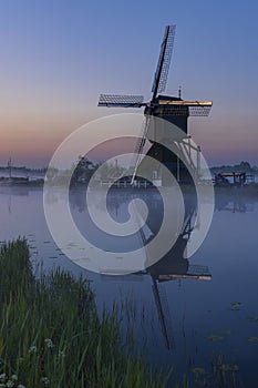 Traditional Dutch windmills with a colourful sky just before sunrise in Kinderdijk, The Netherlands