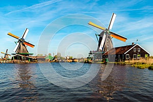 Traditional dutch windmills located by the river Zaan, in Zaanse Schans, Netherlands photo