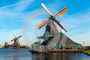 Traditional dutch windmills located by the river Zaan, in Zaanse Schans, Netherlands photo