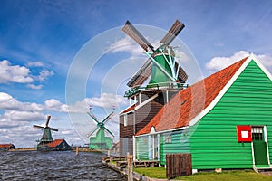 Traditional Dutch windmills with tulips in Zaanse Schans, Amsterdam area, Holland