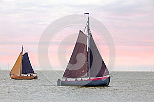 Traditional dutch wooden boats at the IJsselmeer in Friesland the Netherlands at sunset