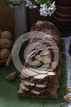 Traditional Easter bread with chocolate and nut filling on a wooden background.