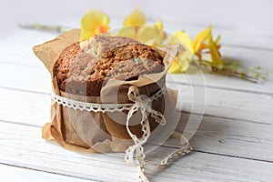 A traditional Easter cake and festive decoration on a white wooden surface