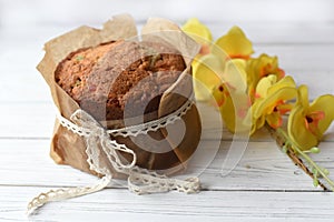 A traditional Easter cake and festive decoration on a white wooden surface