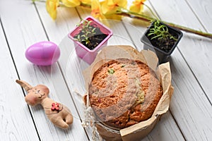 A traditional Easter cake and festive decoration on a white wooden surface